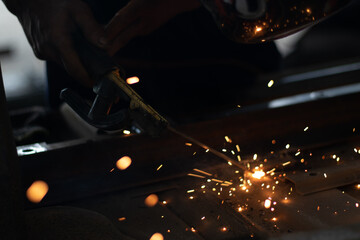 Worker,welding in a car factory with sparks, manufacturing, industry