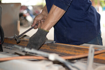 Worker,welding in a car factory with sparks, manufacturing, industry