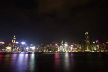 Naklejka na ściany i meble City landscape. Victoria Harbor and Hong Kong skyscrapers at night.