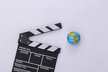 Movie clapper board and globe on white background. Filmmaking, Movie production, Entertainment...