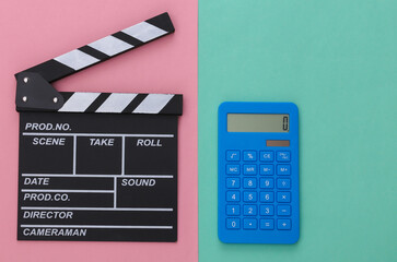 Fototapeta na wymiar Movie clapper board and calculator on pink blue background. Cinema fees. Filmmaking, Movie production. Top view