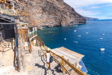 A young tourist descending the stairs to reach the cove of Puerto de Puntagorda, island of La...
