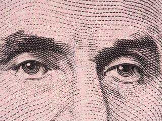 Abraham Lincoln eyes extreme macro onUS 5 dollar bill, united states money closeup, 2013 series