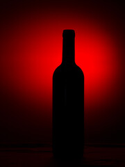 Wine bottle silhouette on the red gradient background with copy space