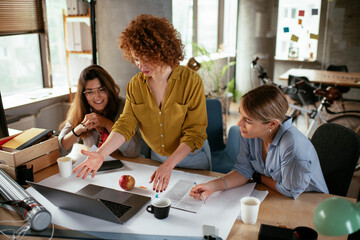 Businesswomen working on a new project. Colleagues discussing about problem they have to solved..