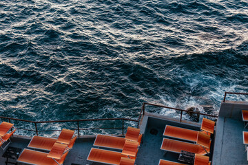 Colourful vintage deck chairs near the sea at golden hour in Marseille Corniche Kennedy