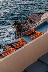 Colourful vintage deck chairs near the sea at golden hour in Marseille Corniche Kennedy