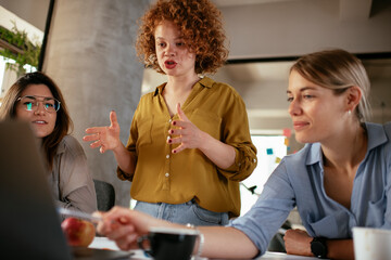 Businesswomen working on a new project. Colleagues discussing about problem they have to solved..