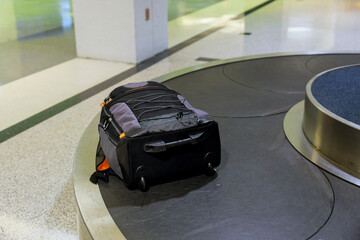 Suitcase or luggage with conveyor belt on baggage claim at the airport