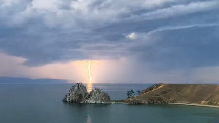 Thunderstorm on Lake Baikal. Lightning strikes through the Shamanka rock