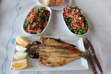 delicious fish and salads on presentation plate