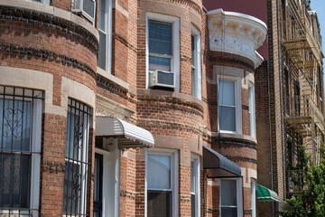 Naklejka premium Row of Old Brownstone Homes and Residential Buildings in Astoria Queens New York