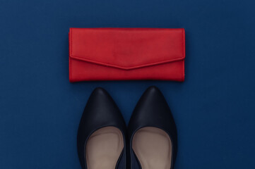 Fashionable leather high heel shoes and wallet on a classic blue background. Color 2020. Top view.
