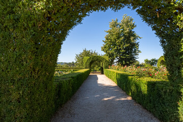 Fototapeta na wymiar View of a pedestrian path on iconic and geometric classic baroque garden