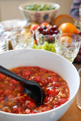 A traditional Slavic dessert Kissel made with local strawberries and rhubarb alongside white wine served from authentic crystal glasses. Celebrating the anniversary in Helsinki, Finland in June 2020.