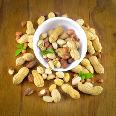Mix the beans together in a white bowl and place on a brown wooden table.