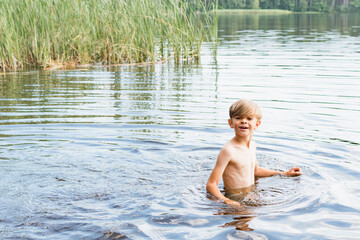 Little boy swimming in the lake