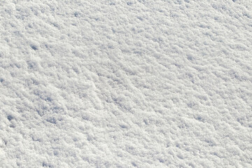 Rough snow texture in sunny weather, winter background