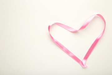 Heart from a pink tape on white with copy space