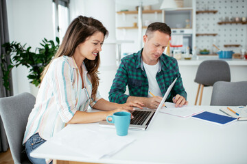 Husband and wife preparing bills to pay. Young couple having financial problems..