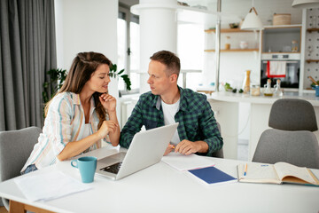 Husband and wife preparing bills to pay. Young couple having financial problems..