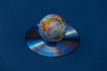Globe and CD on classic blue background. Color 2020.