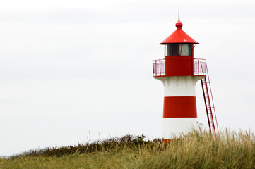 Red and white lighthouse in Denmark in the dunes