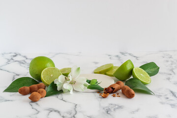 A staged mock up with sweet tamarind, green lemon and some blooms for cosmetics advertising
