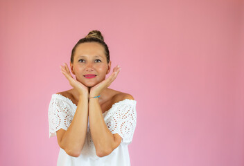 Portrait of a beautiful woman smiling on pink background