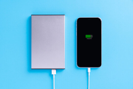 phone charging with external power supply on blue background