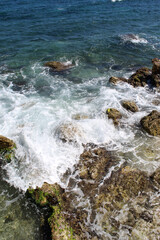 Seascape with waves breaking on the rocks shore at the Greek island of Paros.
