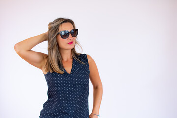 Beautiful woman in blue shirt and sunglasses posing