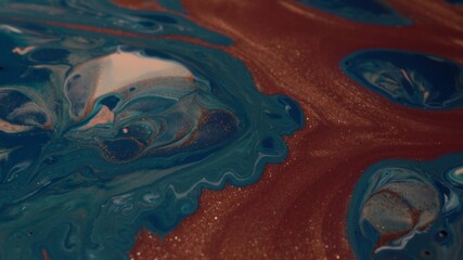 Blue, white and copper metallic colors mix. Paint movement macro. Glitter Ink flow. Fluid Art painting. Moving flowing stream of liquid paint. Decorative abstract art background