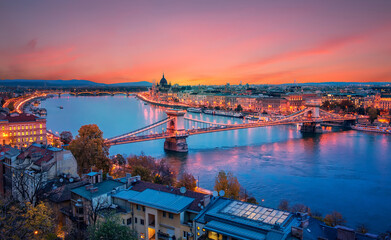 Fantastic picturesque cityscape of Budapest during sunset. panoramic view of Budapest city, Hungarian parliament building and Szechenyi Chain Bridge with stritlight along Danube river, Hungary.