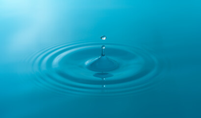 Close-up blue water drops isolated on white background.