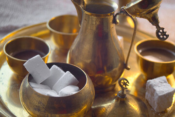 Delicious Bosnian coffee is served with rahat lokum dessert in traditional turkish coffee pot