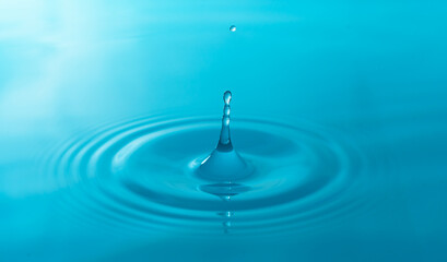 Close-up blue water drops isolated on white background.