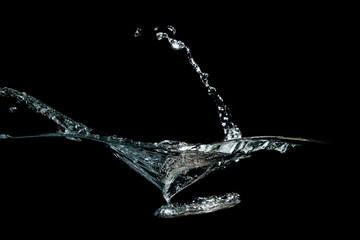 close up of water waves splash and bubbles isolated on black background.