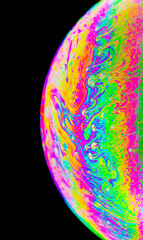 Rainbow colors created by soap, bubble,or oil on black background
