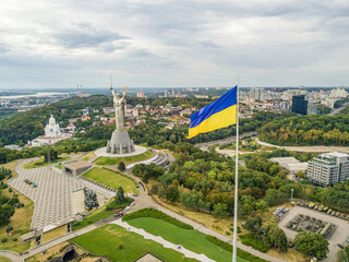 Aerial drone view. Ukrainian flag on a high flagpole in Kiev.