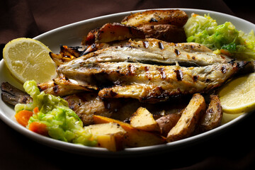 Grilled Sea Bass with Potatoes and Vegetables.