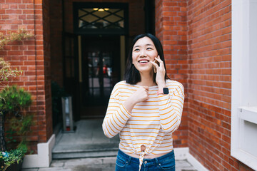 Happy ethnic female having smartphone conversation