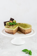 Chocolate mint cashew cake with matcha on a light background. No sugar, lactose, gluten. Healthy food, vegetarian. Selective focus.
