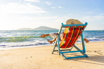 Woman sitting on a chair at the beach