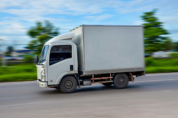 Motion image of the white truck driving on the road  with speed, Motion blur