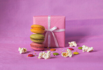 pink party background with gift and colorful candies