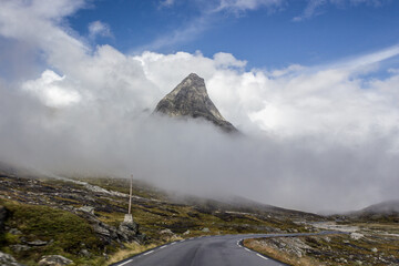Mountain peaks through clouds © Christian