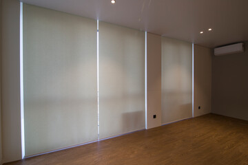 Roller blinds large size for interior windows. Beige color fabric. Control of roller shades using a...