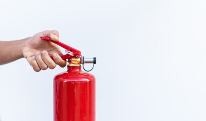 Man hand pressing fire extinguisher on white background and copy space.