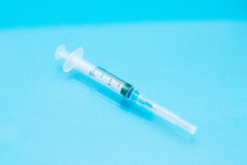 Disposable syringe with needleon a blue background